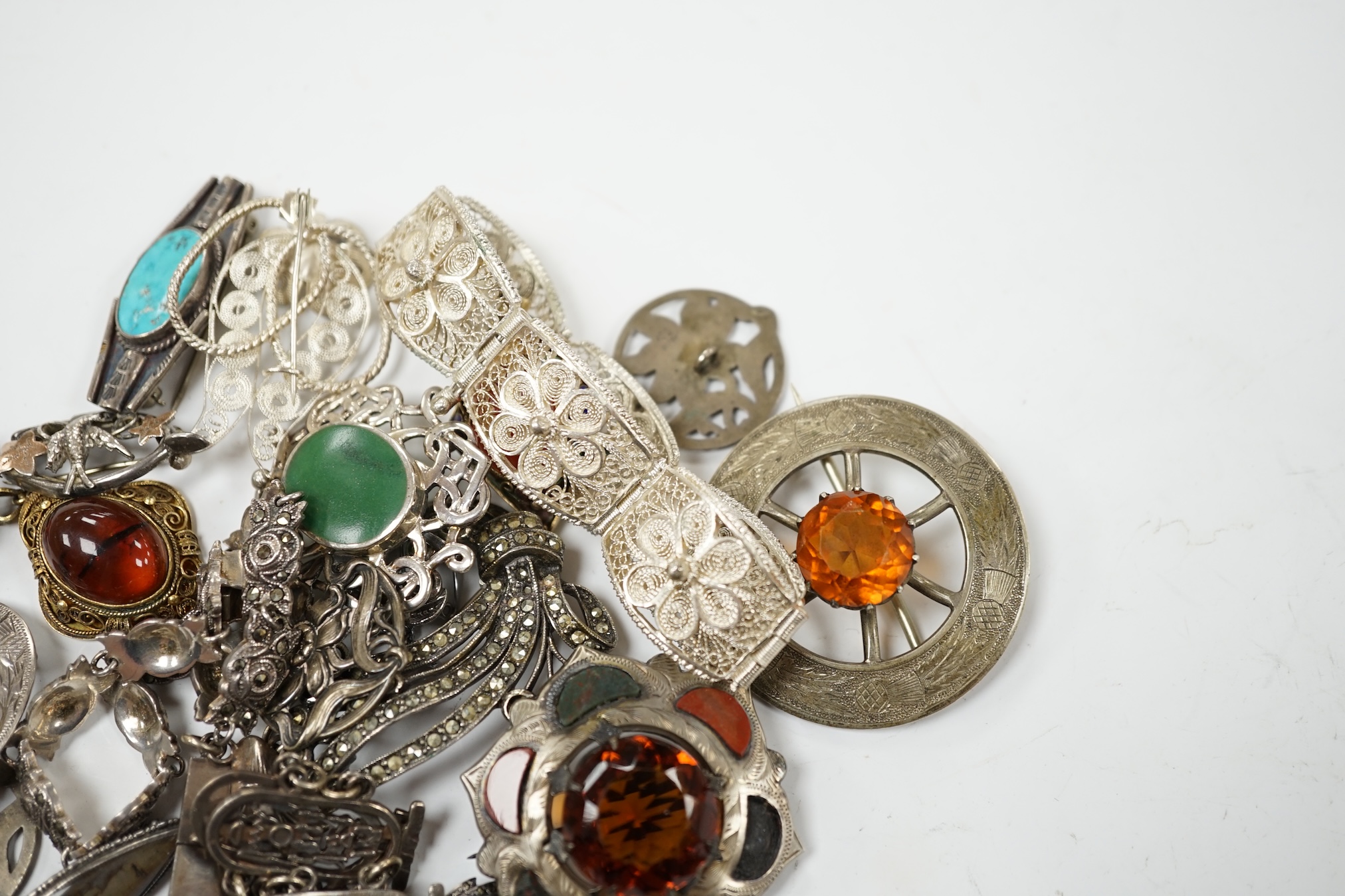 A small quantity of assorted silver and white metal jewellery including filigree bracelet, Scottish hardstone and gem set brooches, etc. Condition - poor to fair
